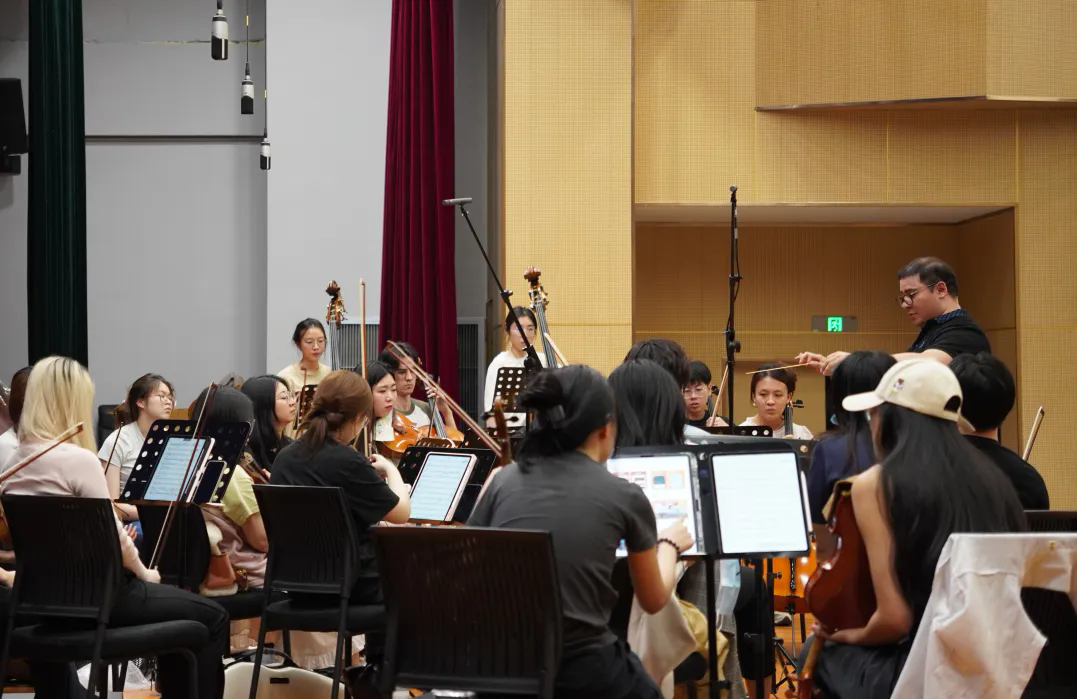 Edwin Roberto Montealegre Carvajal dirige una orquesta en un concierto sinfónico..png