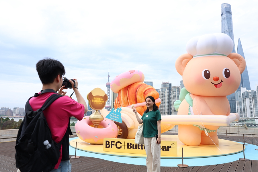 Una visitante posa para una foto junto a una instalación de Butterbear en la azotea del BFC..jpg