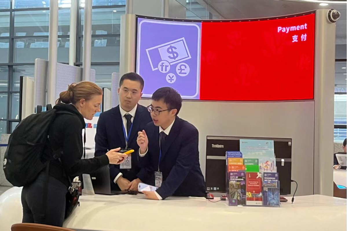 Una viajera internacional visita el nuevo centro de servicio integral abierto las 24 horas en la Terminal 2 del Aeropuerto Internacional Pudong de Shanghai el 29 de junio de 2024.png