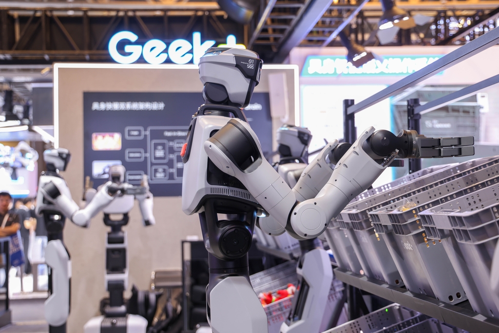 Robots humanoides clasifican artículos en un estand durante la Conferencia Mundial de Inteligencia Artificial de 2026-IC.jpg